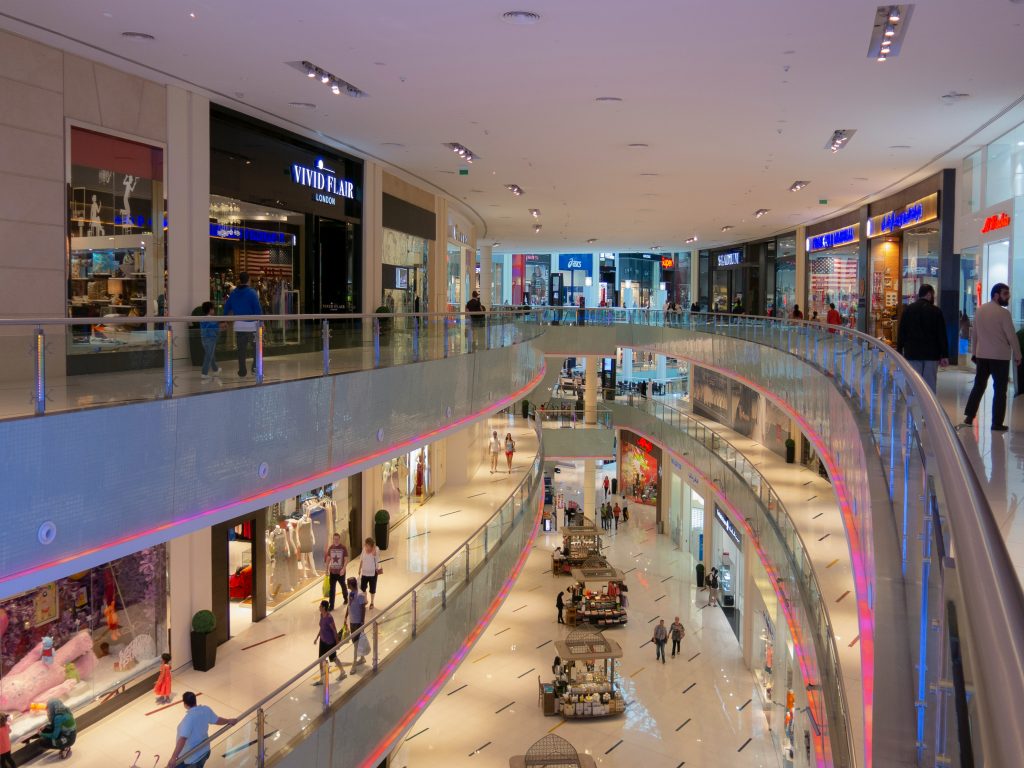Modern multi-level shopping mall interior with curved balconies